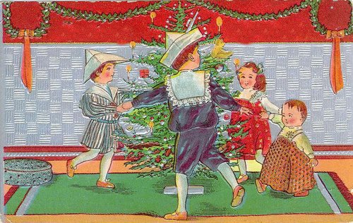 Edwardian Christmas Card: Children Dancing Around Tree with Elegantly Dressed Figure